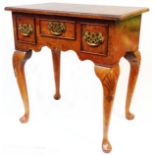 A 68cm reproduction mixed wood lowboy with quarter veneered top and figured walnut front with