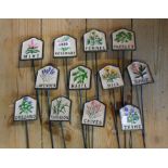 A set of twelve modern painted cast iron herb labels