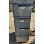 A four drawer metal filing cabinet with grey painted finish containing five plastic file trays -