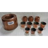 A Victorian copper jelly mould of tall ring form - sold with three smaller similar and a small