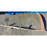 An old garden scythe with long wooden handle