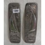 A pair of pewter door plates in the Art Nouveau style, each decorated with a sailing boat