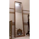 A modern framed narrow oblong wall mirror