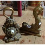 An antique cast brass doorstop of lion head form - sold with a modern similar of grotesque fish