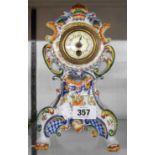 A 19th Century decorative porcelain bombe cased timepiece with polychrome decoration and simple