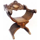 A 19th Century stained oak bishop's chair with ornate back rail and lion's-head pattern terminals to