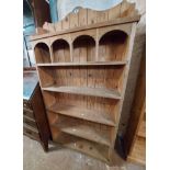 An 86cm pine freestanding five shelf open bookcase with arcaded gallery to top, set on bracket