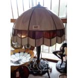 A modern table lamp in the Art Nouveau style with cast metal base and large Tiffany style shade -