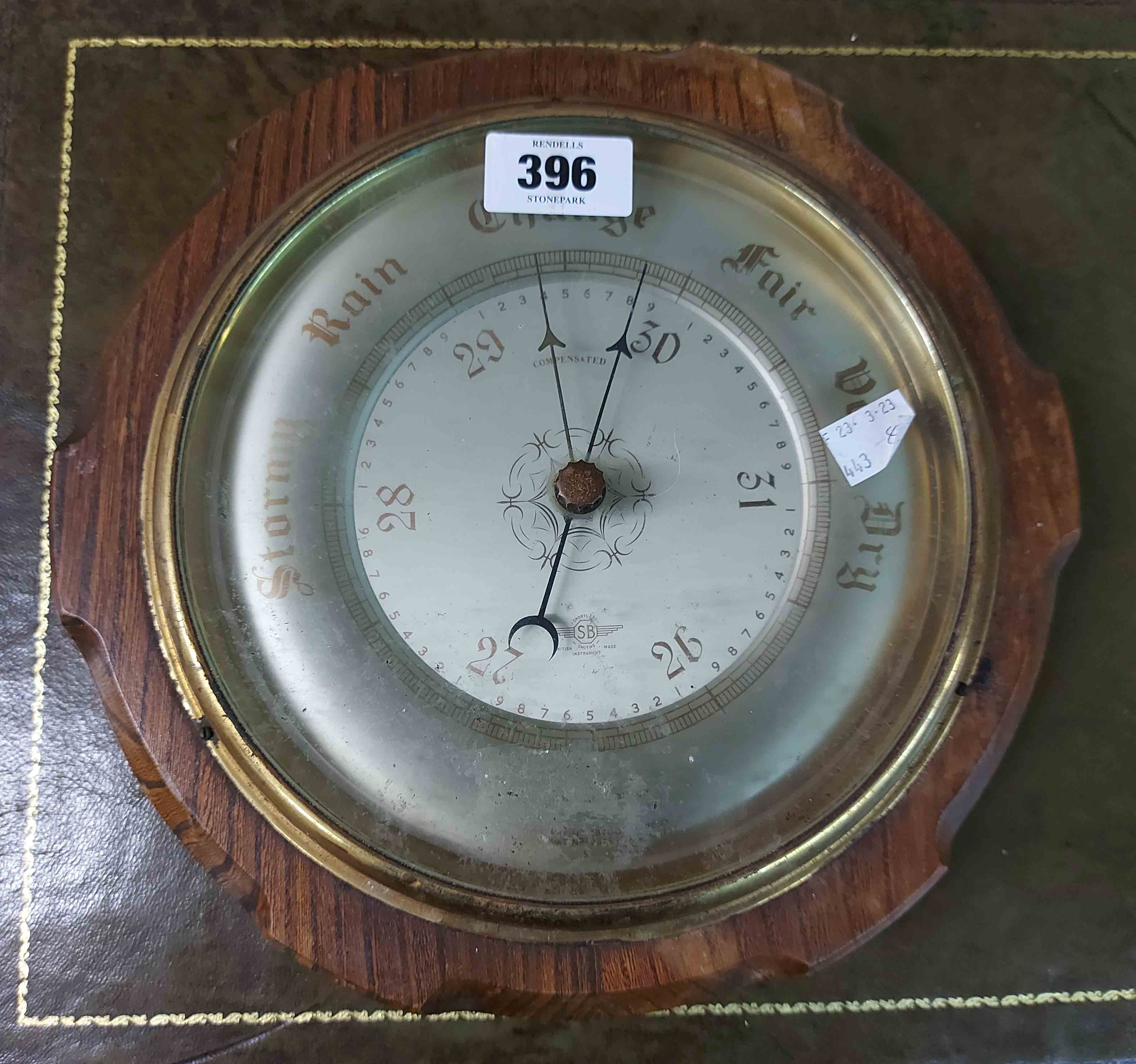 An old oak cased aneroid wall barometer by Shortland Bros.