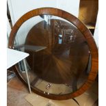 A 1.28m diameter reproduction mahogany and brass bound low two tier table with glass inset top,