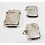 Three silver vesta cases comprising two blank and one with initials - various age and maker