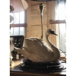 A vintage table lamp, set with large resin swan figurine on a wooden pedestal base with brass lamp