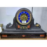A late Victorian black slate and red marble inlaid cased mantel clock with blue enamelled chapter