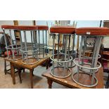 A set of eight vintage bar stools with upholstered tops, set on grey painted metal bases - sold with