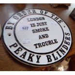 A modern painted cast iron Peaky Blinders sign