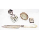 A glass inkwell with silver flip-top lid - sold with a silver knife with mother-of-pearl handle,