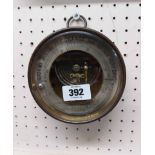 An antique brass cased sedan style aneroid barometer by Dubois & Casse with silvered outer dial,