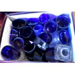 A small box containing a large quantity of blue glass cruet liners, etc.
