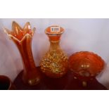 A tall Carnival glass vase decorated in the marigold finish with opalescent rim, a similar vase with