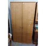 A 100cm retro style teak effect single wardrobe with hanging space and adjustable shelves enclosed