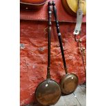 Two copper warming pans