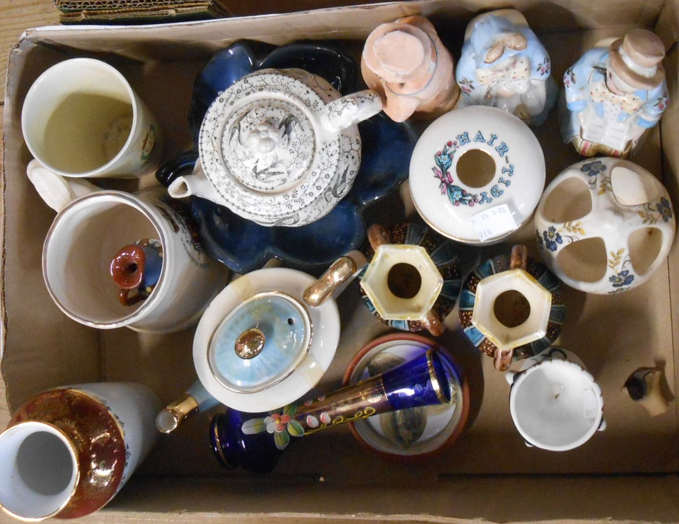 A box containing a quantity of assorted ceramic items including crested china, German nodding