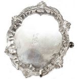 A 17cm diameter George II silver salver with decorative cast rim, set on triple hoof pattern feet by