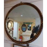 A vintage gilt framed bevelled circular wall mirror with egg and dart border