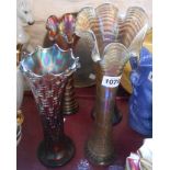 Four tall Carnival glass vases with purple lustre finish of various design and maker