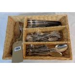 A wicker cutlery tray containing a twelve place setting of German silver plated Rococo design