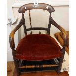 An antique simulated rosewood spindle back child's rocking chair with red velour upholstered