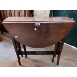 A 66cm Edwardian stained walnut Sutherland table with slatted ends and bearing label for P.E. Gane