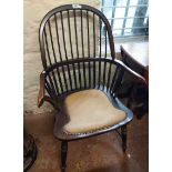 A 20th Century stained wood framed hoop stick back elbow chair with studded upholstery panel to