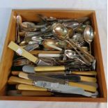A drawer containing a quantity of assorted silver plated cutlery and ivorine handled knives