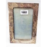 A Chinese white metal fronted photograph frame with upholstered easel back - to take 17cm X 10cm