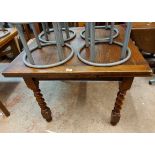 A 91cm vintage oak draw-leaf dining table, set on heavy barley twist legs
