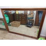 A modern stained wood framed oblong wall mirror - 1.34m X 1.05m