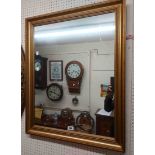 A reproduction gilt framed oblong wall mirror in the antique style