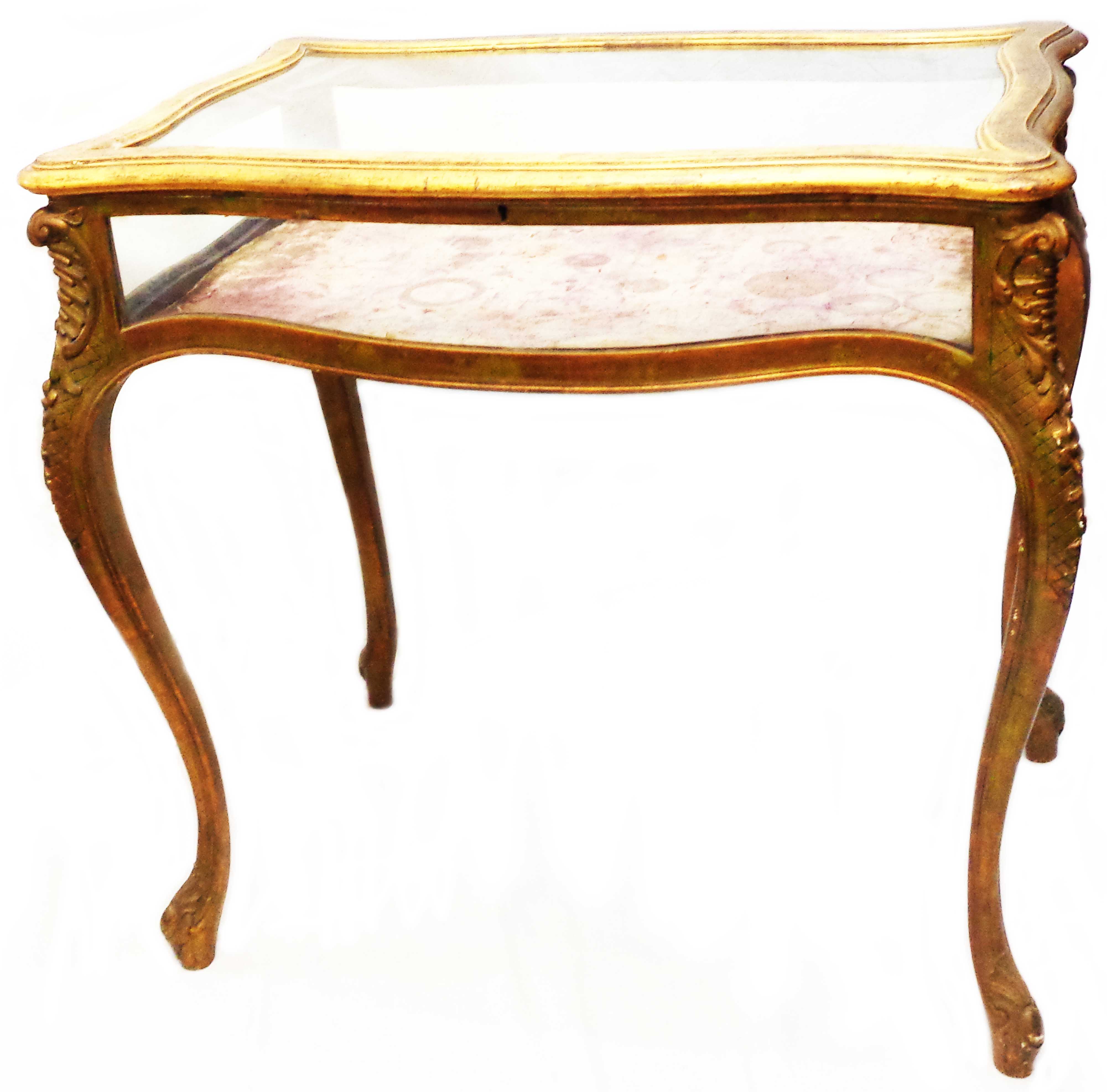 A 79cm late 19th Century giltwood table vitrine of serpentine form with all round glazing and lift-