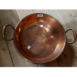 An antique copper two handled pan