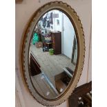 A parcel gilt framed bevelled oval wall mirror - sold with a gilt framed octagonal similar