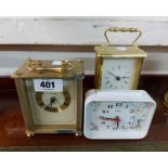 Three small battery clocks, comprising two carriage style and a West German alarm clock