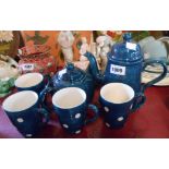 A vintage pottery part tea set comprising teapot, coffee pot and four mugs with blue painted and