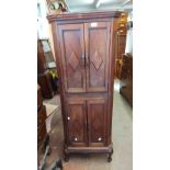 A 47cm early 20th Century mahogany narrow cabinet with shelves enclosed by two pairs of panelled