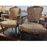 A pair of 20th Century giltwood fauteuil chairs in the Louis XV style with floral woolwork