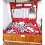 A vintage mixed wood drawer fitted canteen containing a quantity of assorted silver plated cutlery