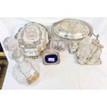Two silver plated entree dishes, two ornate condiments with blue glass liners and a glass decanter