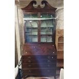A 1.07m 19th Century inlaid mahogany and strung two part bureau/bookcase with swan neck pediment and