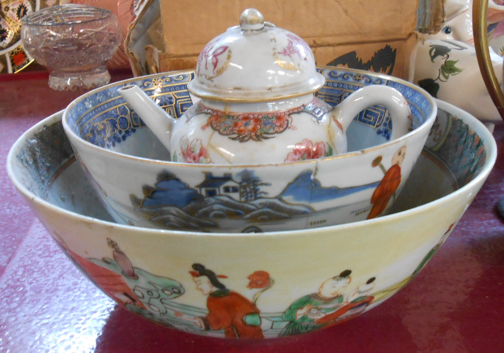 An antique Chinese porcelain famille rose bowl decorated all around with scholars and courtesans