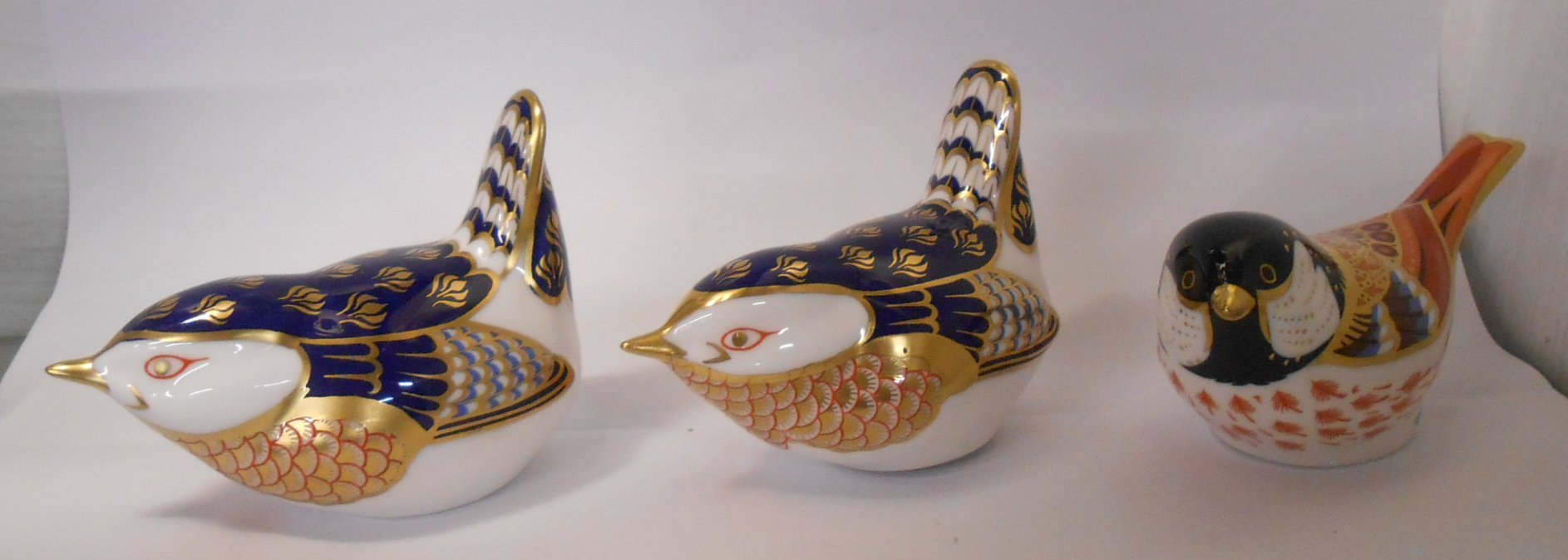 Three Royal Crown Derby bone china paperweights comprising Coal Tit and two wrens - all with gold